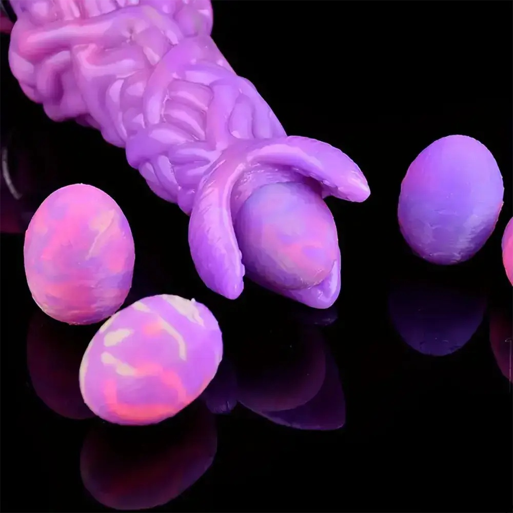 Purple ovipositor dildo laying eggs close-up